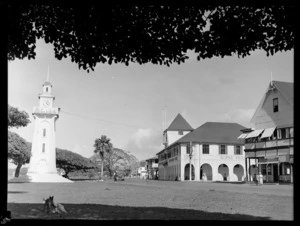 An Apia street scene with beach front clock tower and the Burns Philp Shipping Company building, Western Samoa