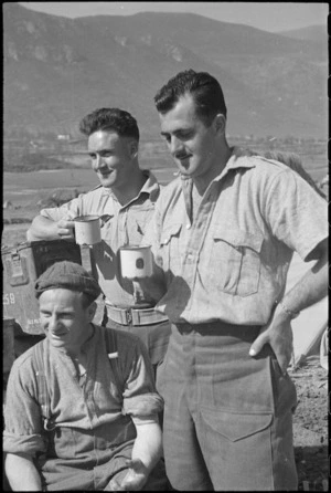 Members of NZ Infantry with mugs of tea behind the lines on the Cassino Front, Italy, World War II - Photograph taken by George Kaye
