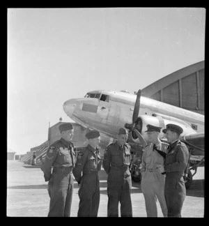 Royal New Zealand Air Force 14th Squadron advance party, members unidentified, with C47 aeroplane, at Whenuapai aerodrome, Auckland