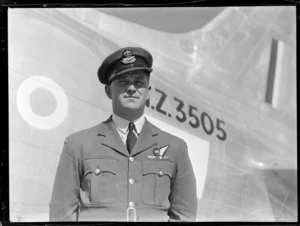 Portrtait of RNZAF Flight Lieutenant AF Jacobsen, W/Opr for survey flight to Japan, at Whenuapai aerodrome, in front of NZ3505 aeroplane