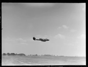 Gloster Meteor aeroplane flying low over RNZAF Station, Hobsonville, Auckland