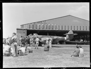 Gloster Meteor aeroplane, being inpected by airmen at RNZAF Station, Hobsonville, Auckland