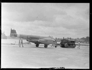 A disassembled Gloster Meteor aeroplane, EE395, towed by a tractor, Hobsonville Air Base, Auckland