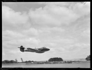 Gloster Meteor aeroplane flying low over airfield, Ardmore Aerodrome, Auckland