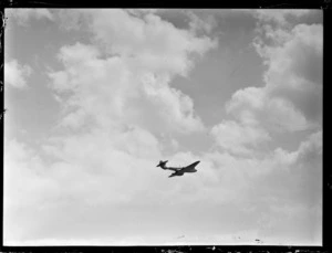 Gloster Meteor aeroplane in flight over RNZAF Station, Hobsonville, Auckland