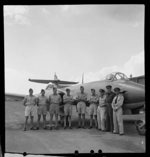 Group of unidentified jet pilots standing in front of an aeroplane, RNZAF Station, Hobsonville, Auckland