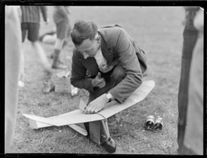 Mr R Truman, with a model aeroplane, at a meeting of the Auckland Model Aero Club, Papatoetoe, Auckland