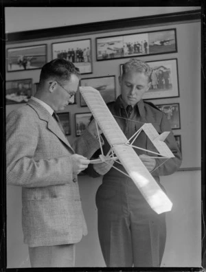 Mr W Craven and Mr LJ Perry holding a model aircraft, [in office of Whites Aviation?]