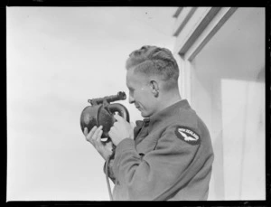 An unidentified RNZAF Airman using a [signalling?] device, Control Tower, Rongotai Airport, Wellington