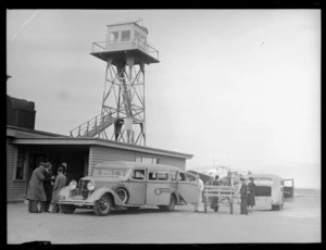 The Union Airways Building and tower with Airways Services bus, Union Airways plane and unidentified passengers, Rongotai Airport, Wellington