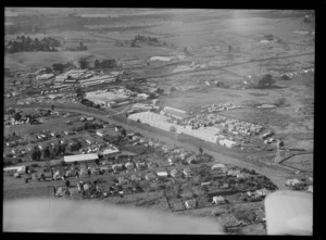 View of Hardies Fibrolite and NZ Forest Products' Pinex Factory, with Penrose Railway Station and Station Road East, Auckland
