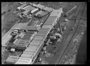 View of the Auckland Farmers' Freezing Works Southdown Factory with railway line, Penrose, Auckland