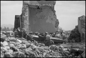 Soldiers moving through ruins on the Cassino battlefront, Italy - Photograph taken by George Kaye
