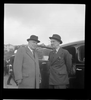 Portrait of Lord Winster, Great Britain's Minister for Civil Aviation, with Walter Nash next to a car, Evans Bay, Wellington City