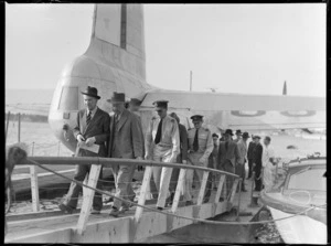 Lord Winster and members of his party, stepping off a Hobart flying boat, Mechanics Bay, Wellington