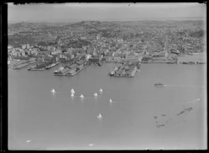 View of Auckland City and waterfront with wharves, cargo ships and yachts, Mount Eden beyond