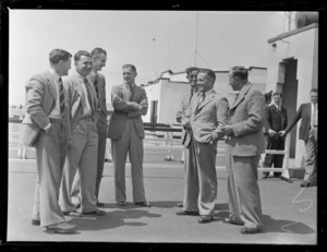 Group portrait of unidentified TEA flying staff watching BOAC Flying boat arriving, [Auckland City Harbour?]