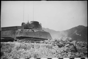 A NZ Sherman tank makes its way through a ruined village in the Cassino area, Italy, World War II - Photograph taken by George Kaye