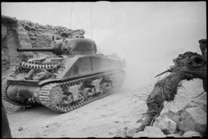 NZ Sherman tank making its way through the ruins of a village on the Cassino Front, Italy, World War II - Photograph taken by George Kaye