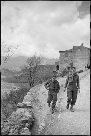 H W Hobson and C H Longworth stroll through village on the Italian Front, World War II - Photograph taken by George Kaye