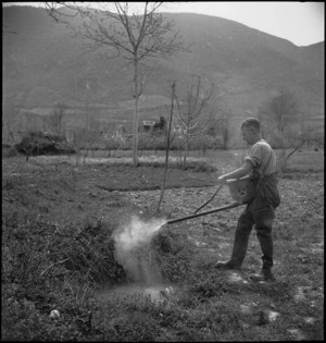 D Brown uses the 'dust gun' at the New Zealand Malarial School in the Volturno Valley, Italy, World War II - Photograph taken by M D Elias