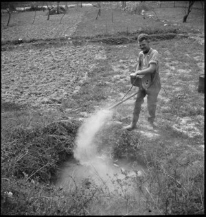 D Brown uses the dust gun at the New Zealand Malarial School in the Volturno Valley, Italy, World War II - Photograph taken by M D Elias