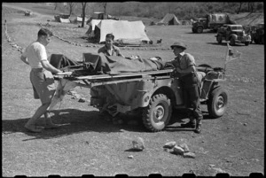 Unloading patients from a stretcher jeep at 6 NZ Field Ambulance in Italy, World War II - Photograph taken by George Bull