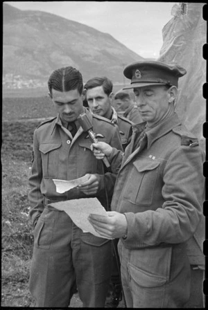 Flight Sergeant M R Cooper records a message to be broadcast in New Zealand, Italy, World War II - Photograph taken by George Bull
