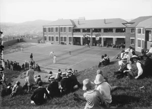 People watching an exhibition game at the opening of the tennis courts at Wellington East Girls College