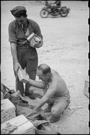 R W Clarkin and D C James packing supplies at the Hove Dump, Cassino area, Italy, World War II - Photograph taken by George Bull