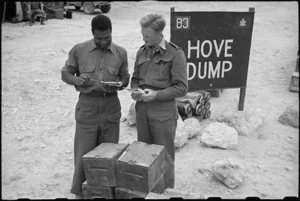 Sergeant J Byer and Sergeant Coventry check out supplies at Hove Dump, Cassino area, Italy, World War II - Photograph taken by George Bull