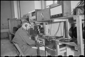 Major M R Fitchett at control table of loud speaker system at the 2 NZ General Hospital, Caserta, Italy, World War II - Photograph taken by George Bull