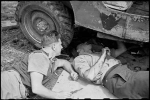 G R Wilmer and M Phillips repair their jeep in the Volturno Valley, Italy, World War II - Photograph taken by George Bull