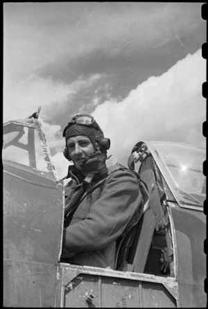 Flying Officer L J Montgomery at the controls of his Spitfire aeroplane in the Volturno Valley, Italy, World War II - Photograph taken by George Bull