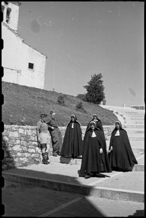 A Graham and R J Richardson watch passing nuns on steps leading to Campobasso castle, Italy, during World War II - Photograph taken by George Bull