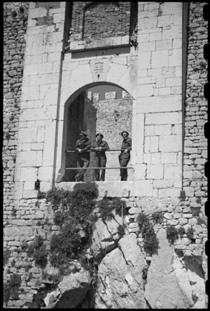 New Zealand troops on leave stand in the old gateway to the castle of Campobasso, Italy, World War II - Photograph taken by George Bull