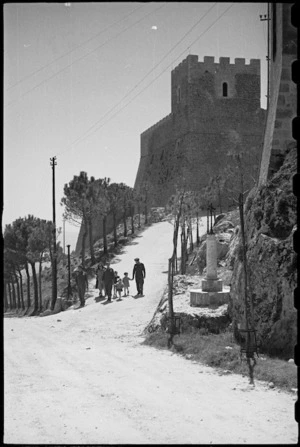 New Zealanders on leave in Campobasso, Italy, walk with locals down commemorative avenue of pines - Photograph taken by George Bull