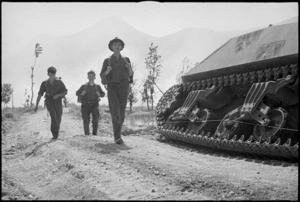 Infantrymen leaving ruins of Cassino pass knocked out tank, Italy, World War II - Photograph taken by George Kaye