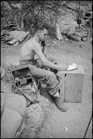 E Dominey at Platoon HQ receives message from Company HQ in forward areas of 8th Army Front, Italy World War II - Photograph taken by George Kaye
