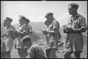Kiwis noting results of event at 5 NZ Infantry Brigade Sports Meeting in Volturno Valley area, Italy, World War II - Photograph taken by George Kaye