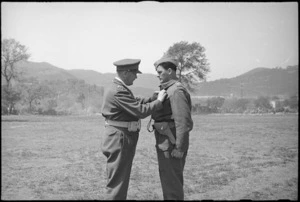 Lieutenant Colonel H M McElroy receiving bar to his DSO from General Freyberg at parade in Volturno Valley, Italy, World War II - Photograph taken by George Kaye