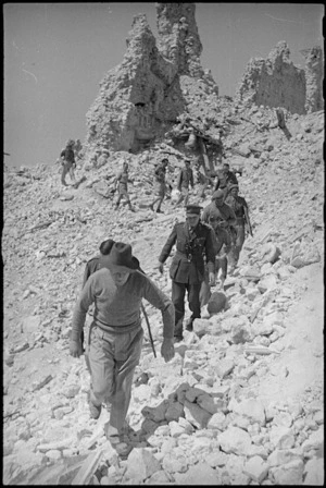 Prime Minister Peter Fraser leads his party among the ruins of the monastery at Cassino, Italy, World War II - Photograph taken by George Kaye