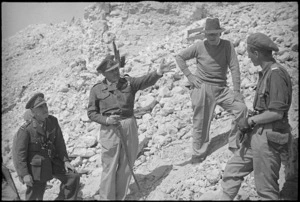 General Bernard Freyberg explains feature of recent Cassino fighting to Peter Fraser and General Edward Puttick, Italy, World War II - Photograph taken by George Kaye