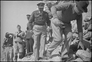 Prime Minister Peter Fraser, followed by General Bernard Freyberg, clambers over ruins of Cassino Monastery, Italy, World War II - Photograph taken by George Kaye