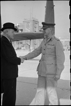 Prime Minister Peter Fraser greeted by Brigadier W G Stevens at an airport near Naples, Italy, World War II - Photograph taken by George Bull