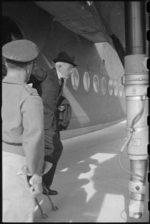 Prime Minister Peter Fraser alighting from an aeroplane at an airport near Naples, Italy, World War II - Photograph taken by George Bull