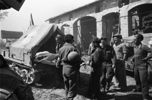 A forward NZ Regt Aid Post in the Senio Area, Italy, attends to wounded, who are evacuated on Red Cross carriers