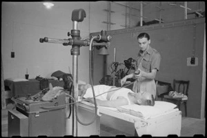 R Mirams at work in the X-Ray Department of the 1 New Zealand General Hospital, Molfetta, Italy, World War II - Photograph taken by George Bull