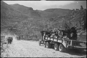 Tank transporter carrying bulldozer moving through the ruins of Cassino, Italy, World War II - Photograph taken by George Kaye