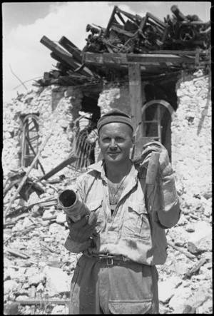 M C Smith with a German 'leaflets shell' used to distribute propaganda in Cassino, Italy, World War II - Photograph taken by George Kaye